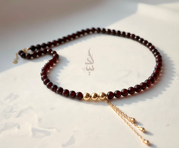 Handcrafted necklace with 18K gold beads and chain paired with natural garnet stone