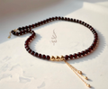 Handcrafted necklace with 18K gold beads and chain paired with natural garnet stone