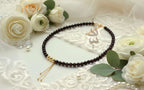 Handcrafted necklace with 18K gold beads and chain paired with natural garnet stone