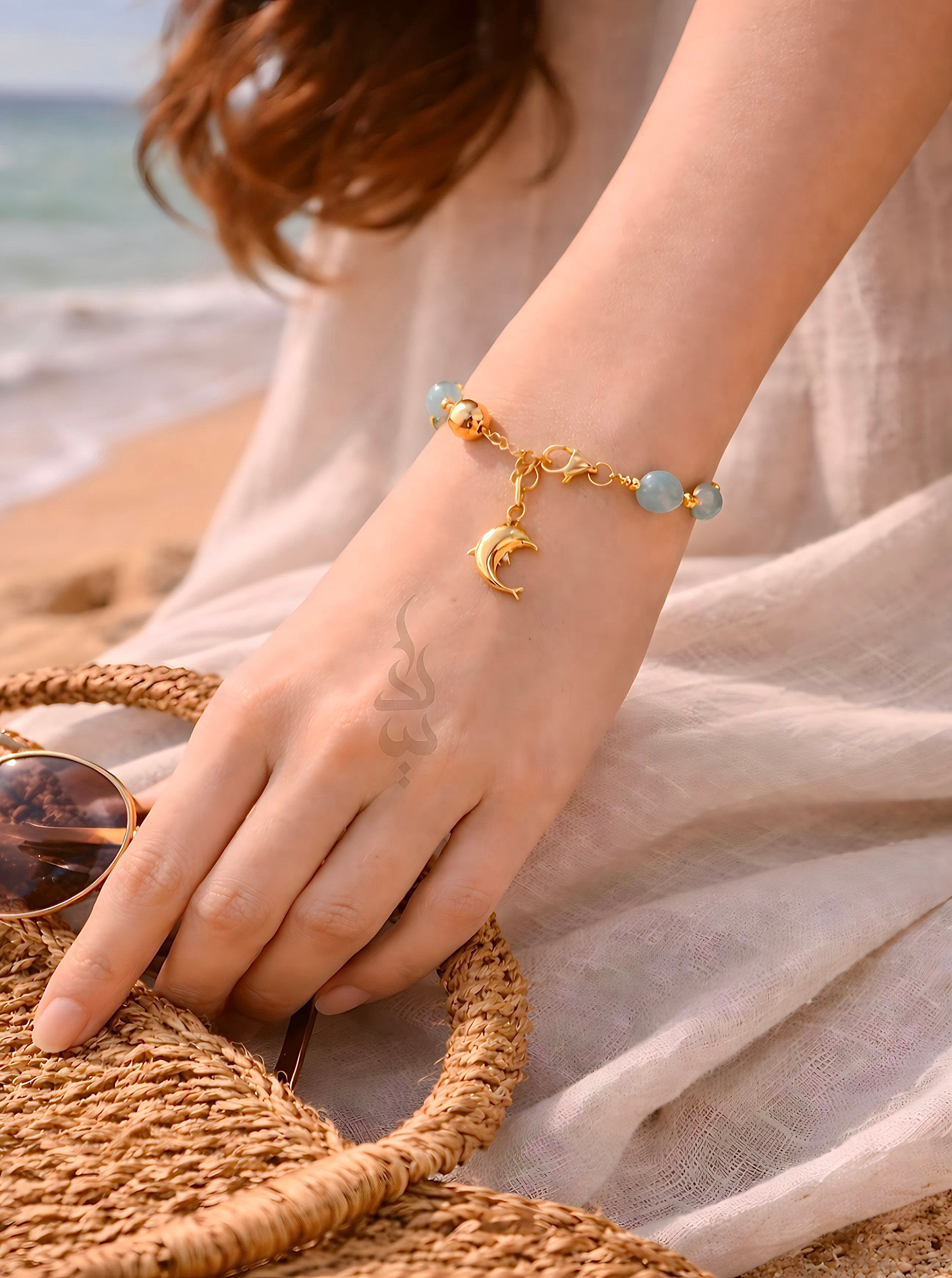 18K gold bracelet with a dolphin charm crafted with ammonite stone