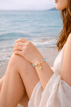 18K gold bracelet with a dolphin charm crafted with ammonite stone
