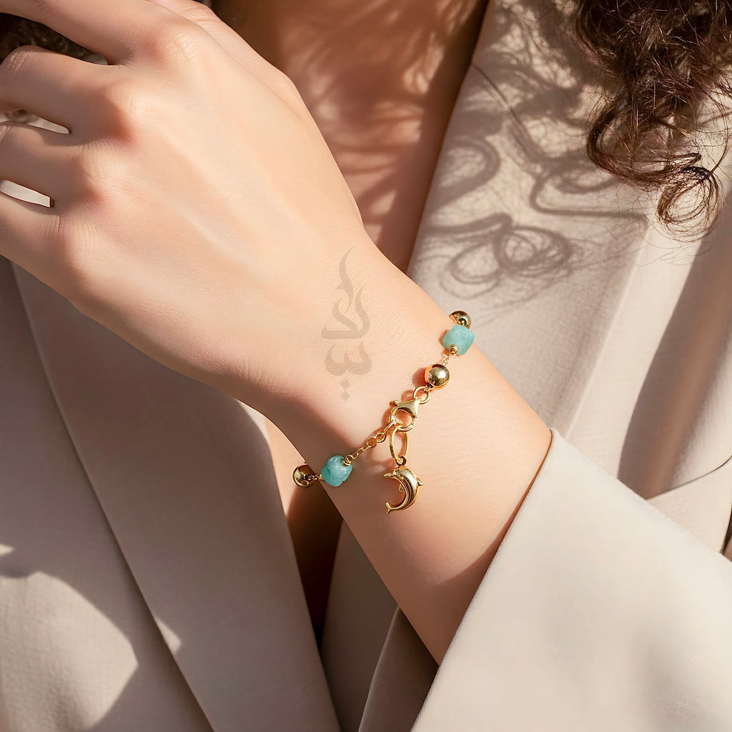 18K gold bracelet with a dolphin charm crafted with ammonite stone