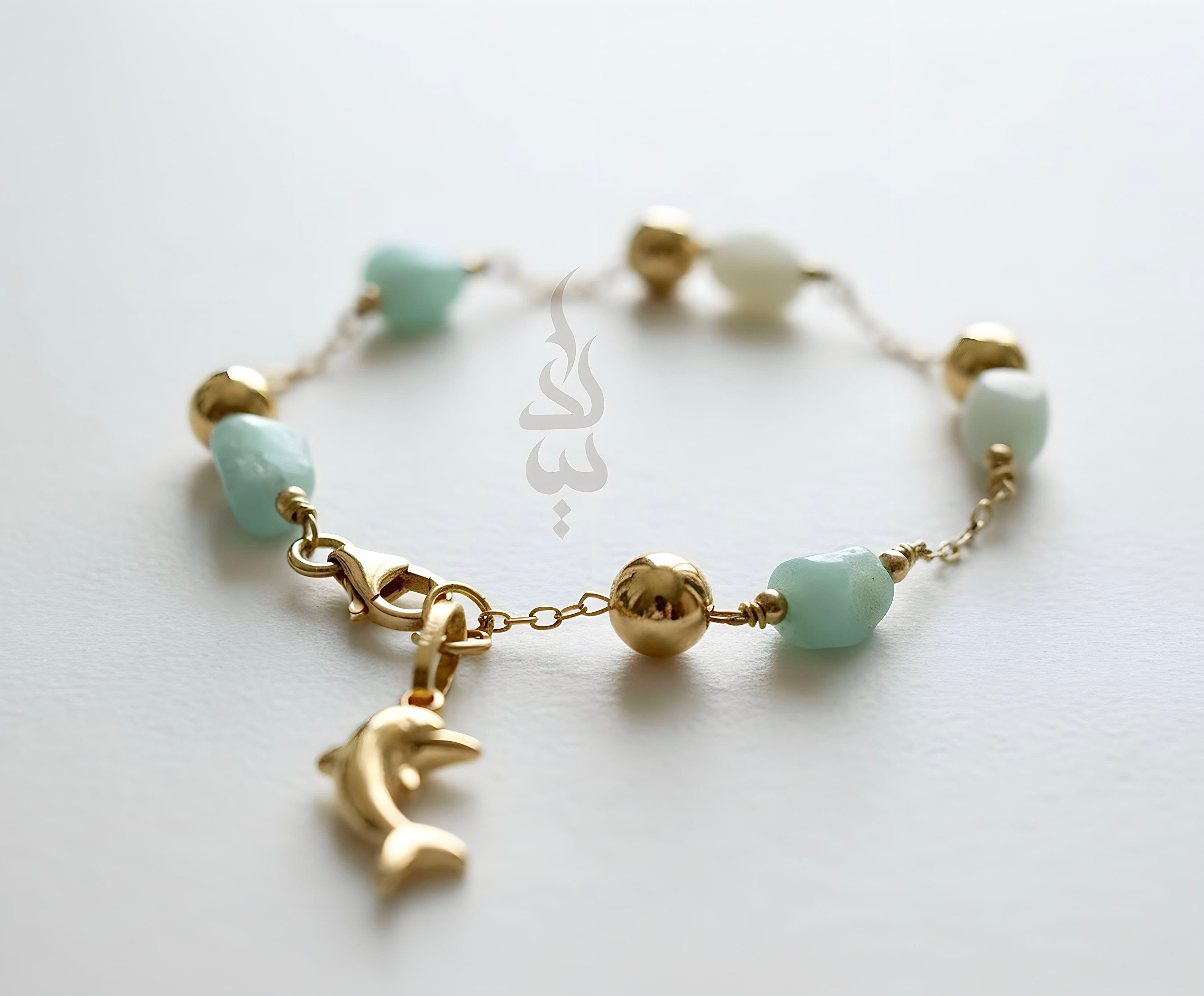 18K gold bracelet with a dolphin charm crafted with ammonite stone