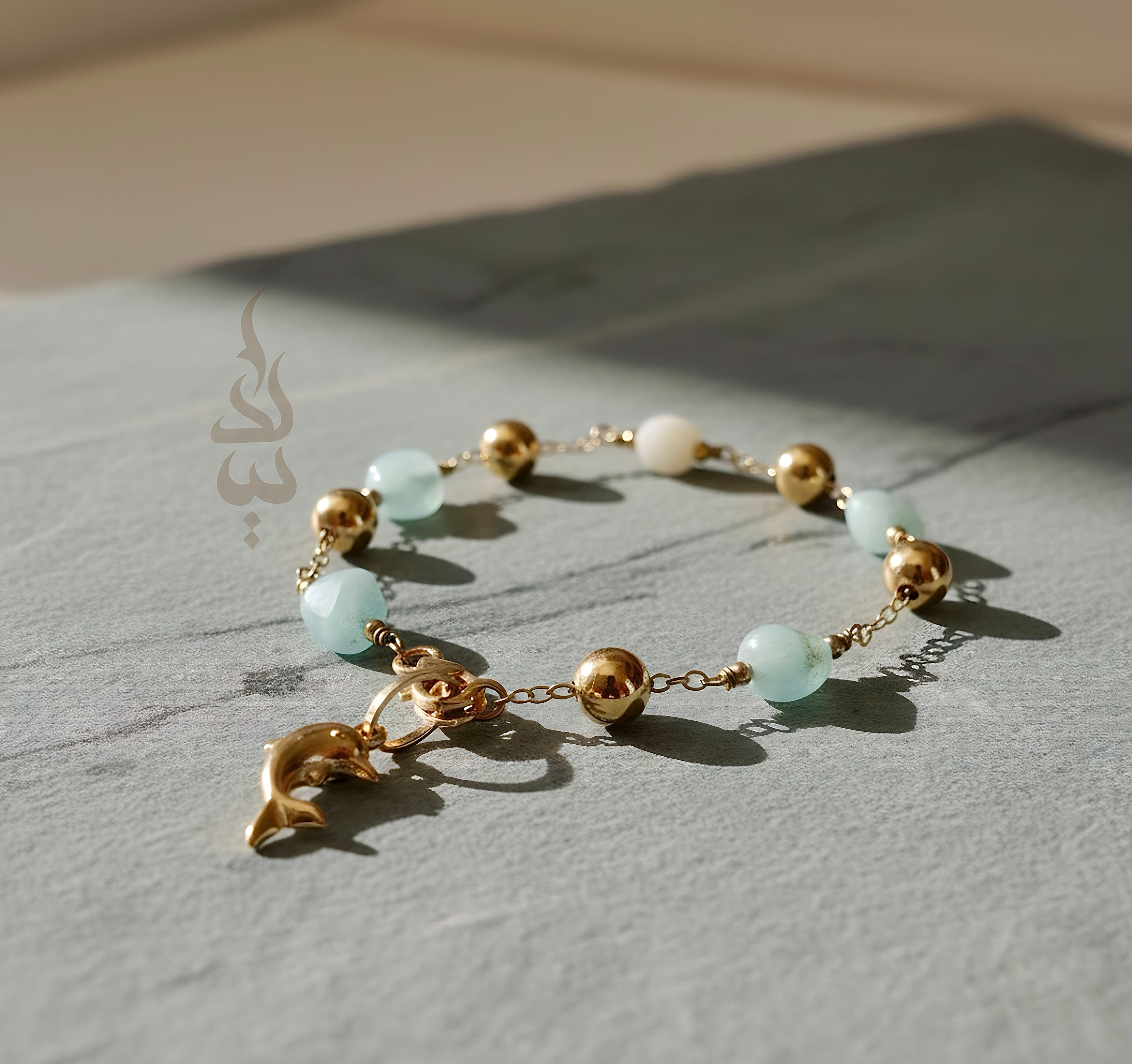 18K gold bracelet with a dolphin charm crafted with ammonite stone