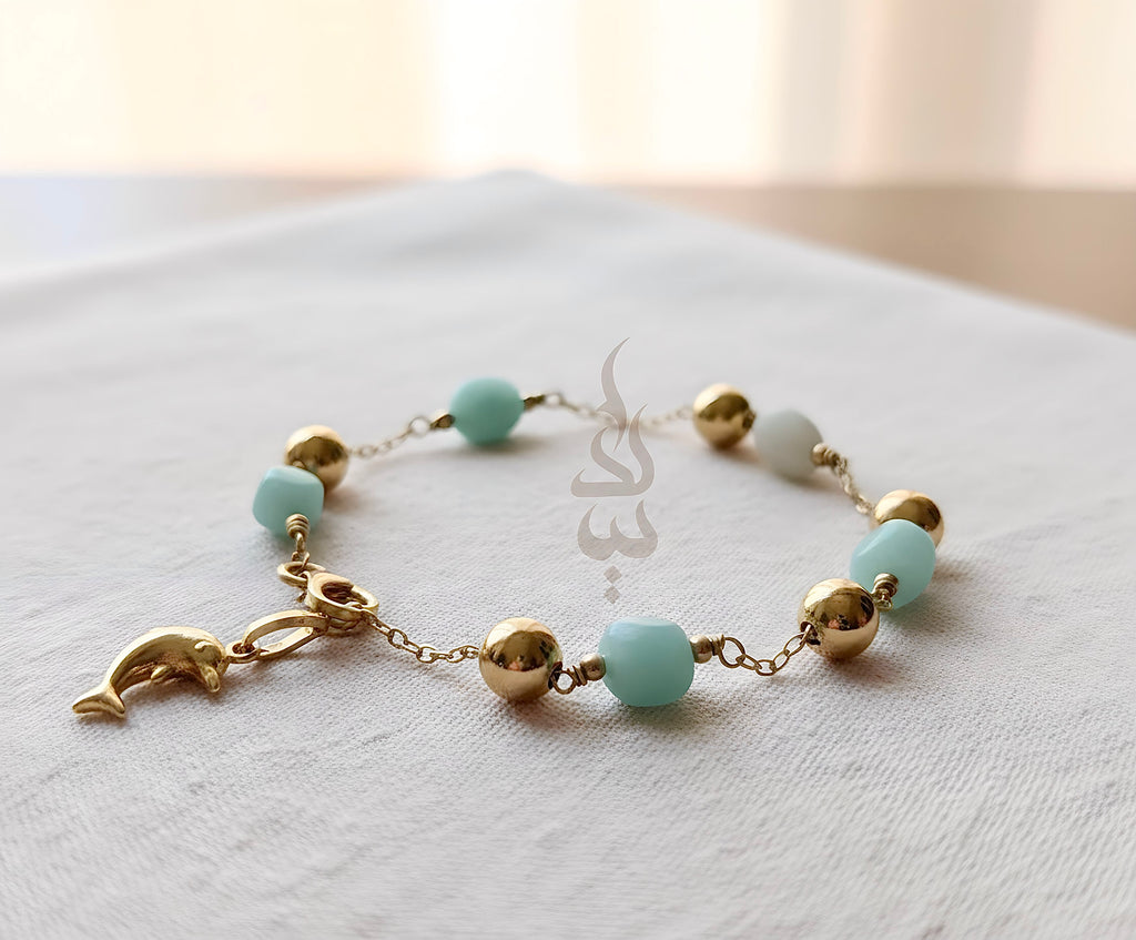 18K gold bracelet with a dolphin charm crafted with ammonite stone