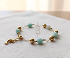 18K gold bracelet with a dolphin charm crafted with ammonite stone