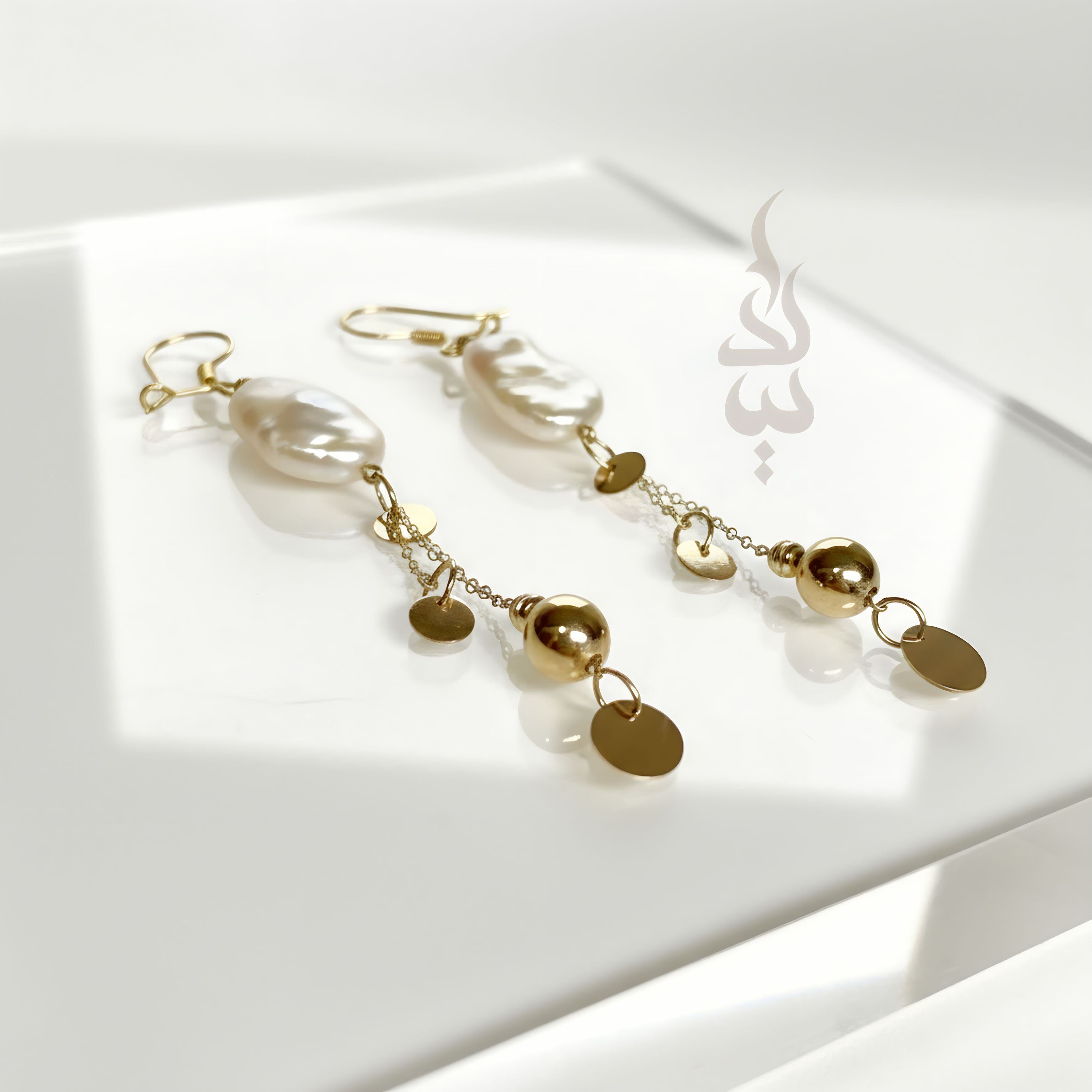 18K gold earrings crafted with a natural baroque pearl