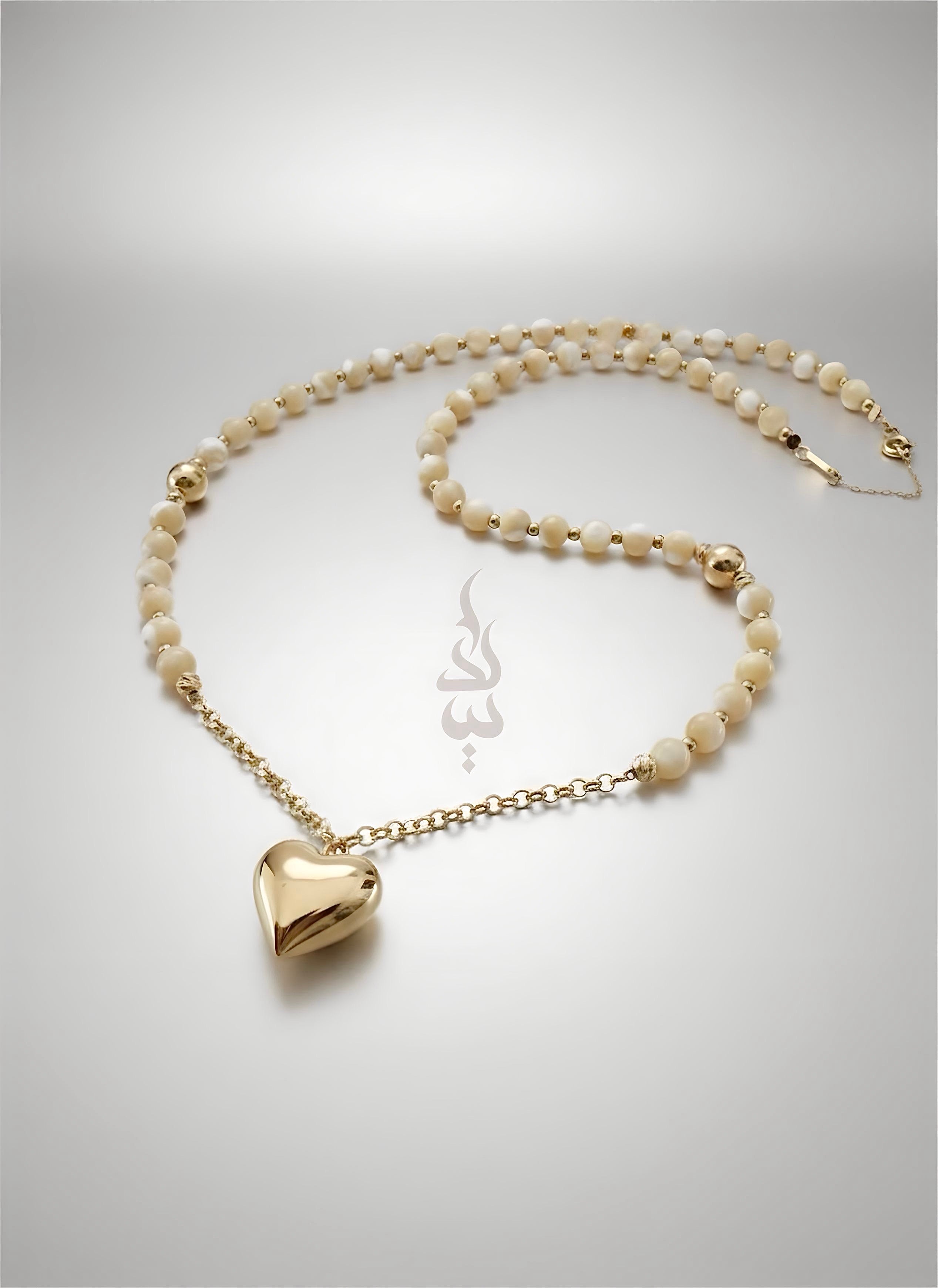 18K gold necklace with a heart pendant crafted with shell
