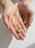 18K gold necklace with a heart pendant crafted with shell