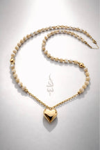 18K gold necklace with a heart pendant crafted with shell