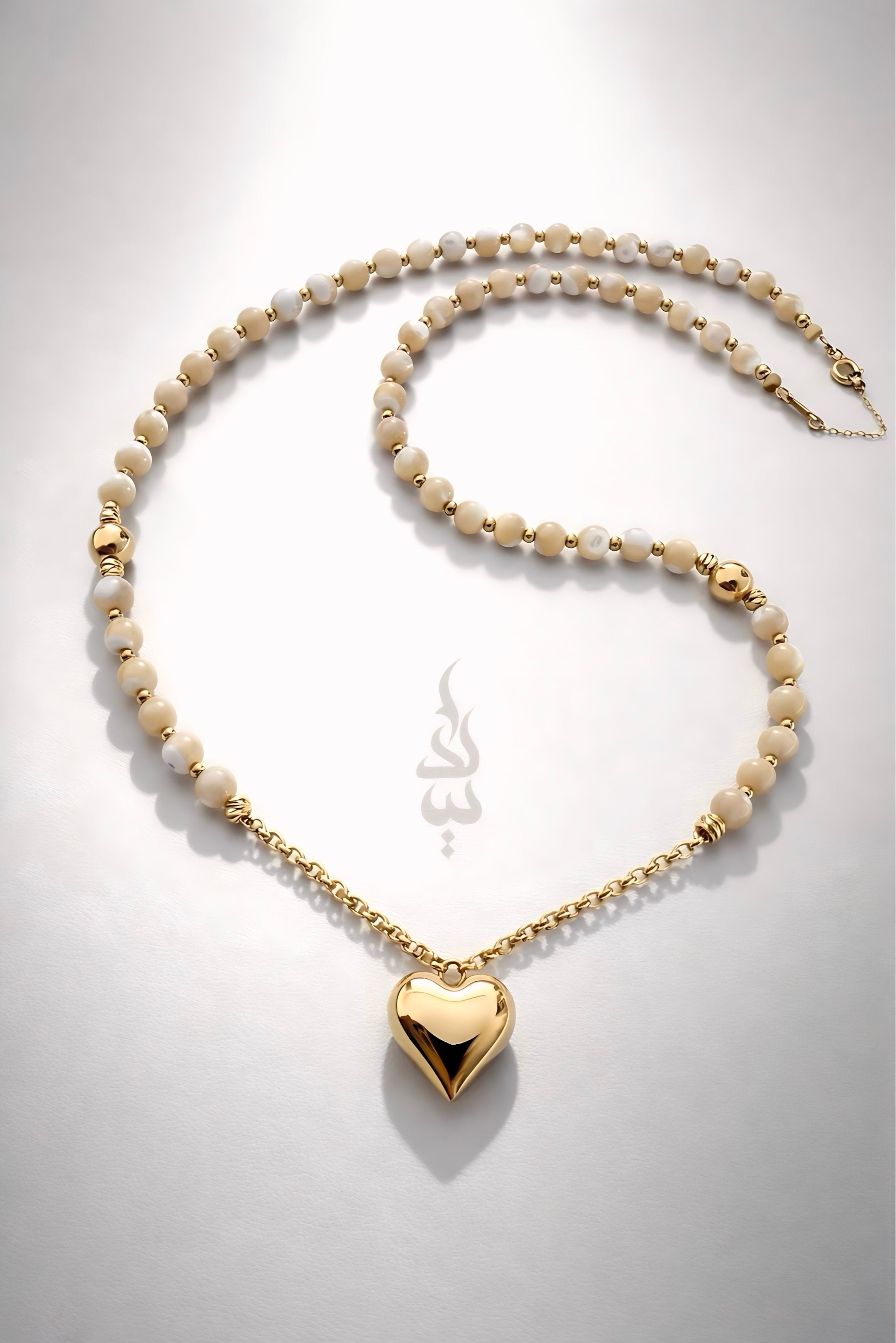 18K gold necklace with a heart pendant crafted with shell
