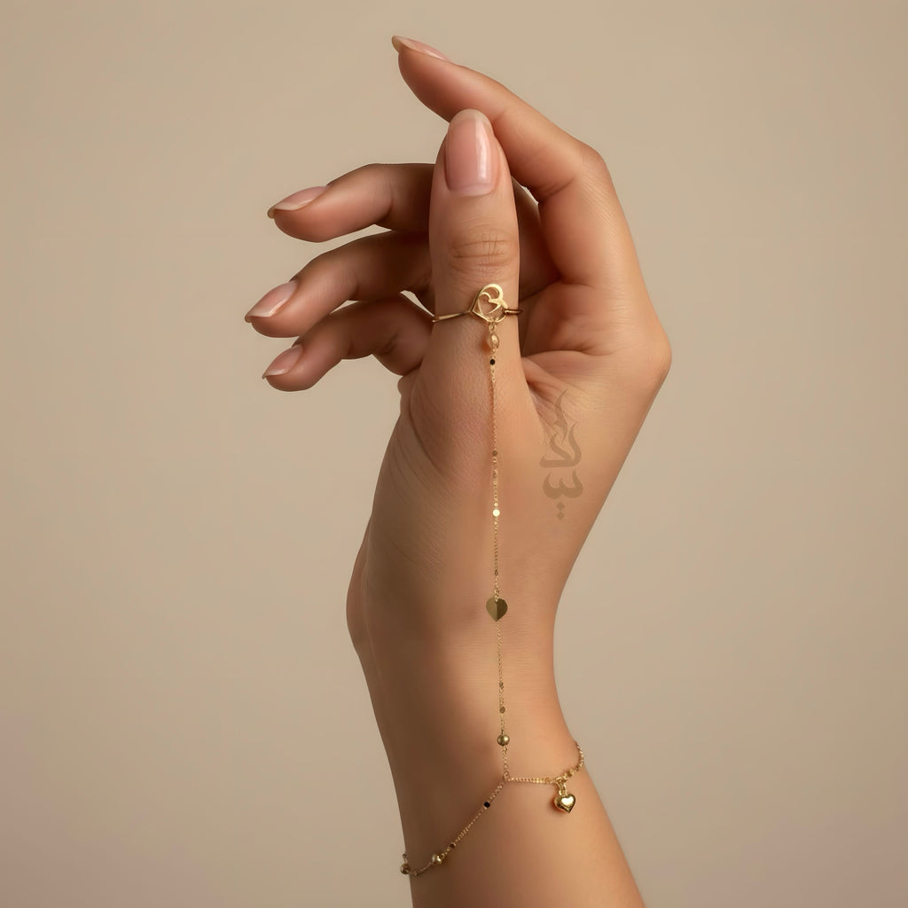 18K Gold hand chain with delicate heart charms and tiny beads