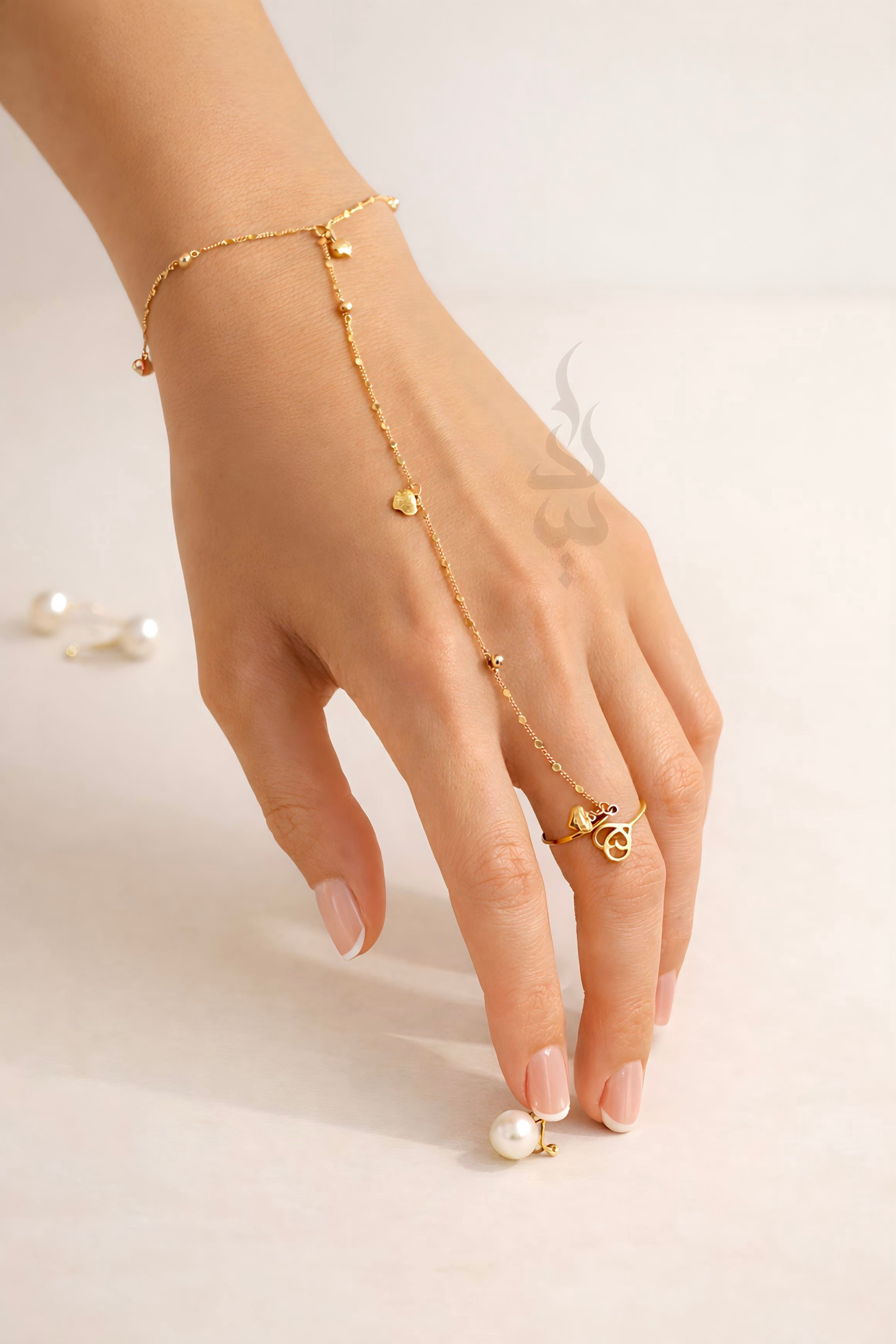 18K Gold hand chain with delicate heart charms and tiny beads