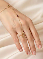 18K Gold hand chain with delicate heart charms and tiny beads