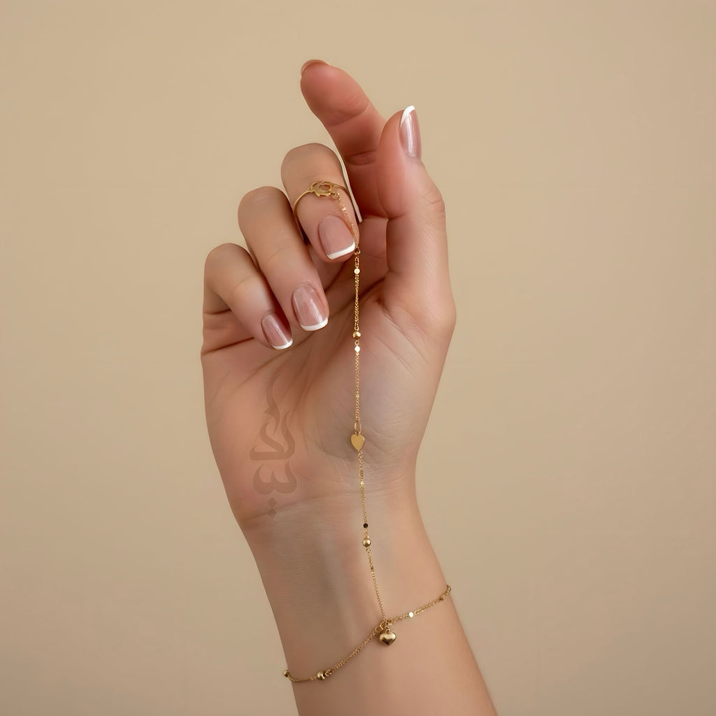 18K Gold hand chain with delicate heart charms and tiny beads