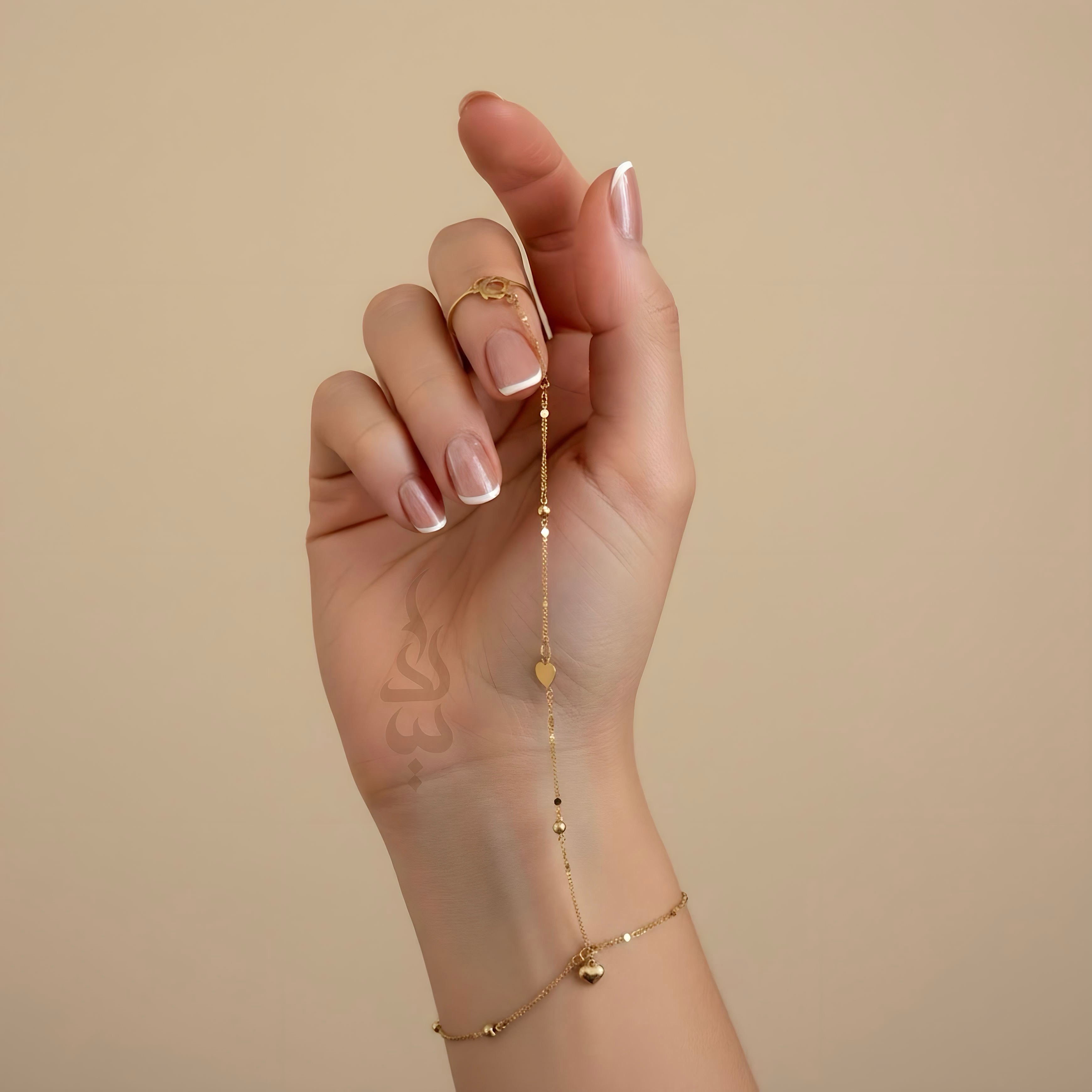 18K Gold hand chain with delicate heart charms and tiny beads