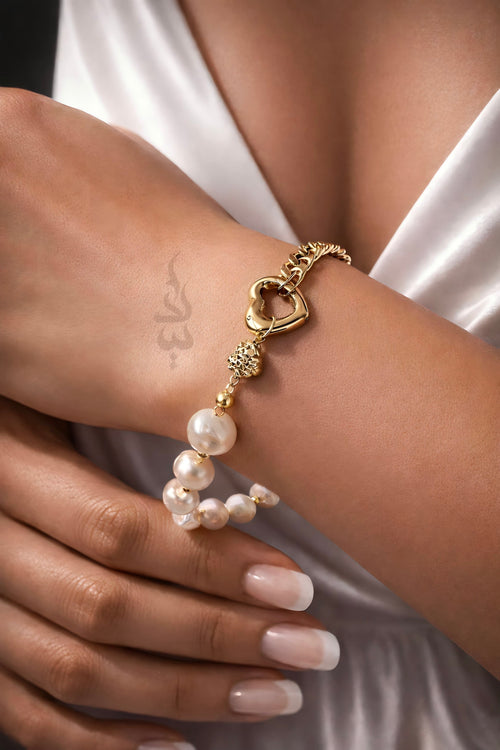 18K gold bracelet with a heart charm crafted with natural pearls