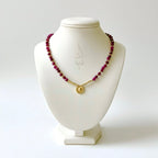 18K gold necklace crafted with ruby stones and Versace pendant