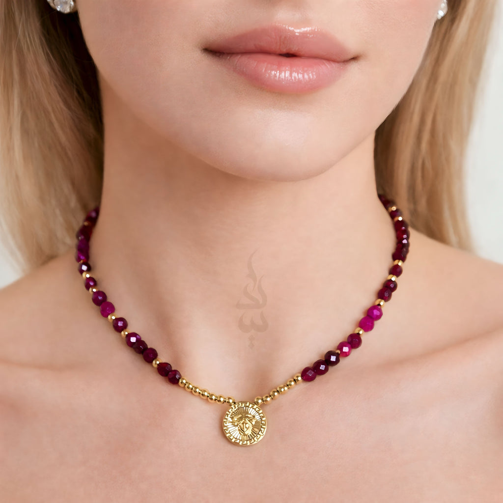18K gold necklace crafted with ruby stones and Versace pendant