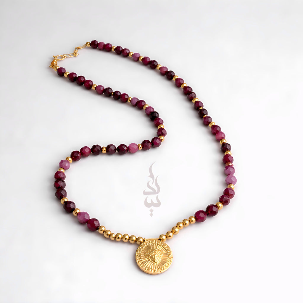 18K gold necklace crafted with ruby stones and Versace pendant
