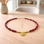 18K gold necklace crafted with ruby stones and Versace pendant