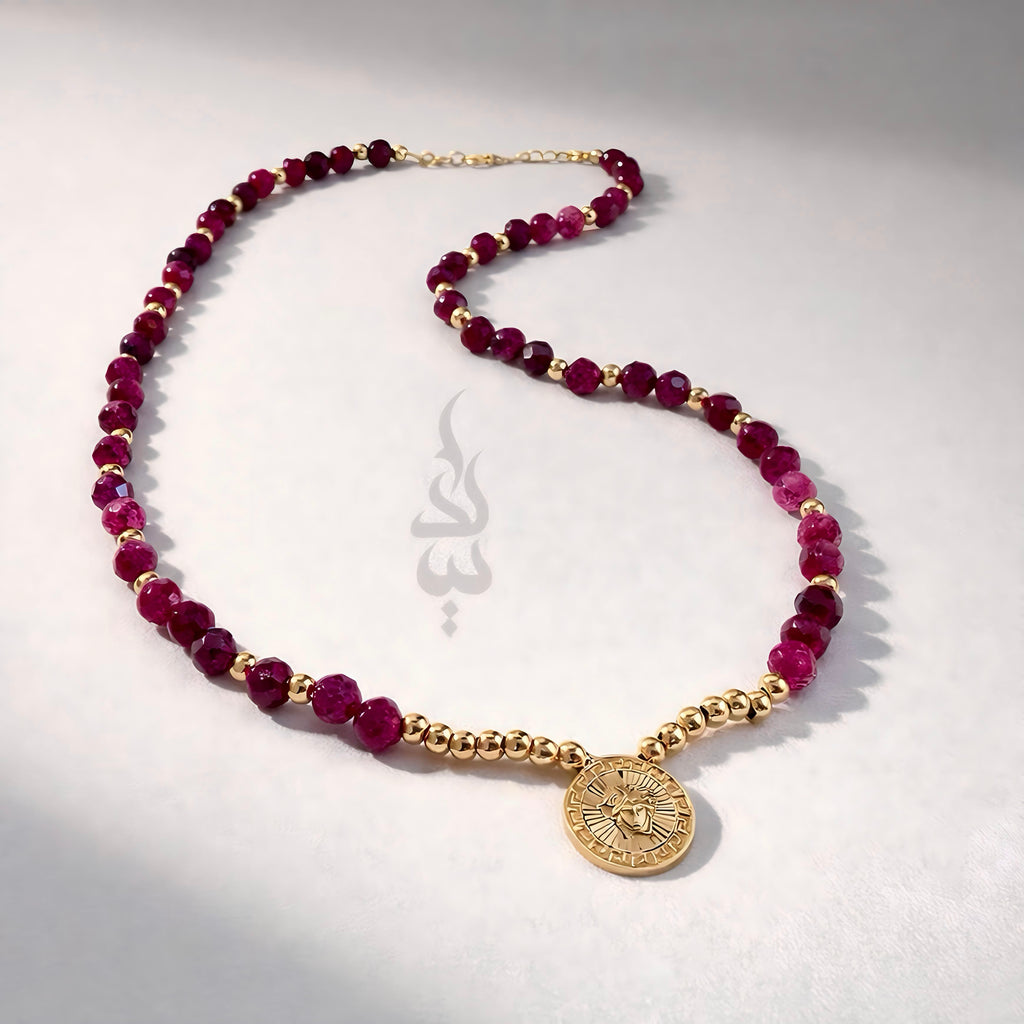 18K gold necklace crafted with ruby stones and Versace pendant