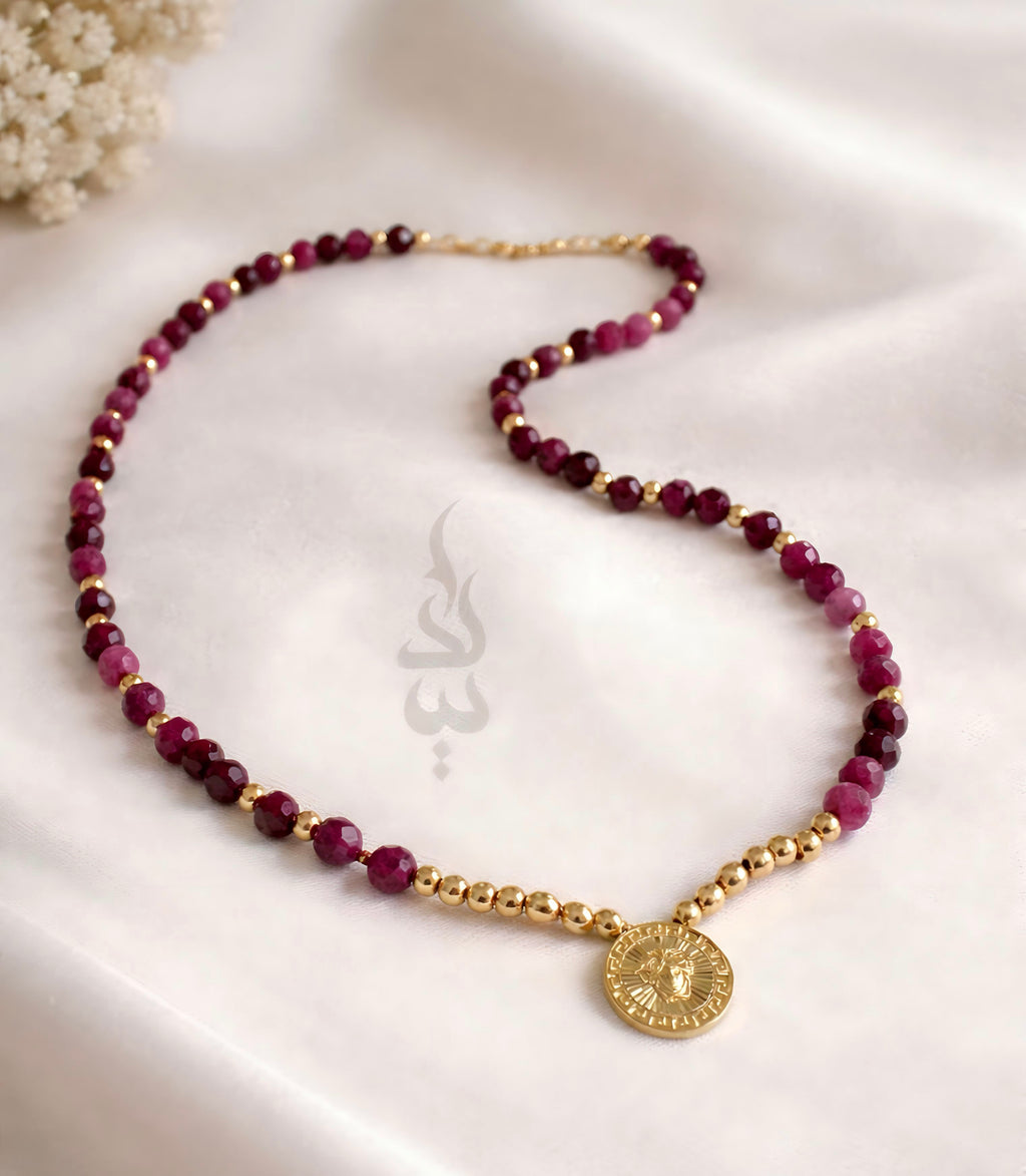 18K gold necklace crafted with ruby stones and Versace pendant