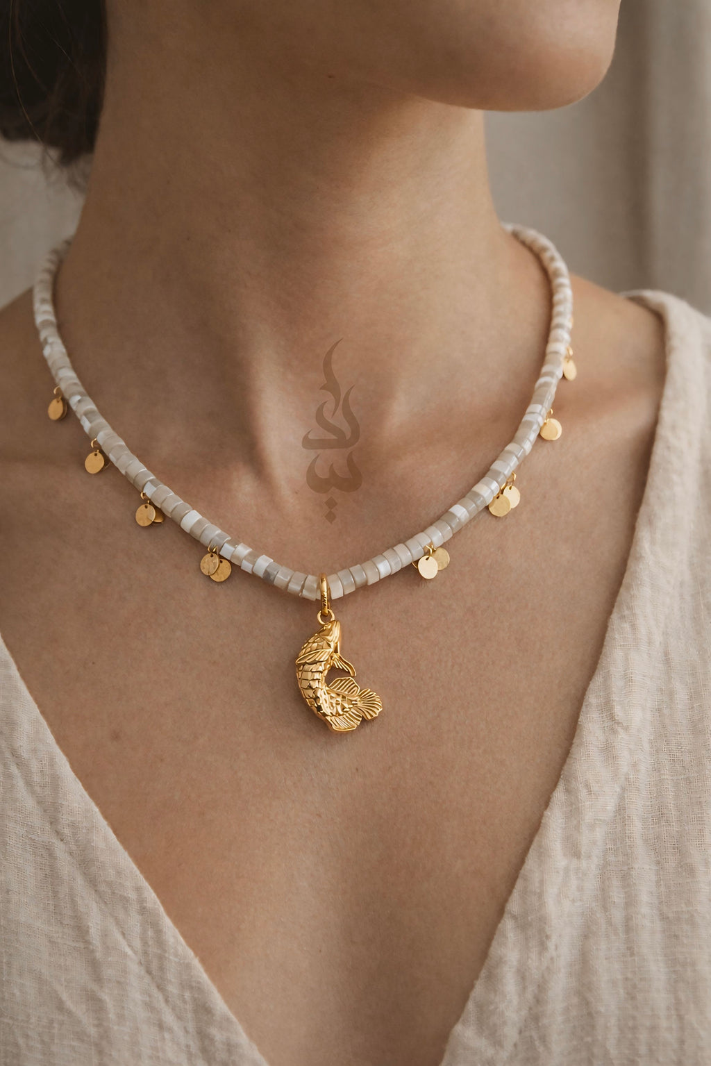 18K gold necklace with a fish pendant and shiny gold scales
