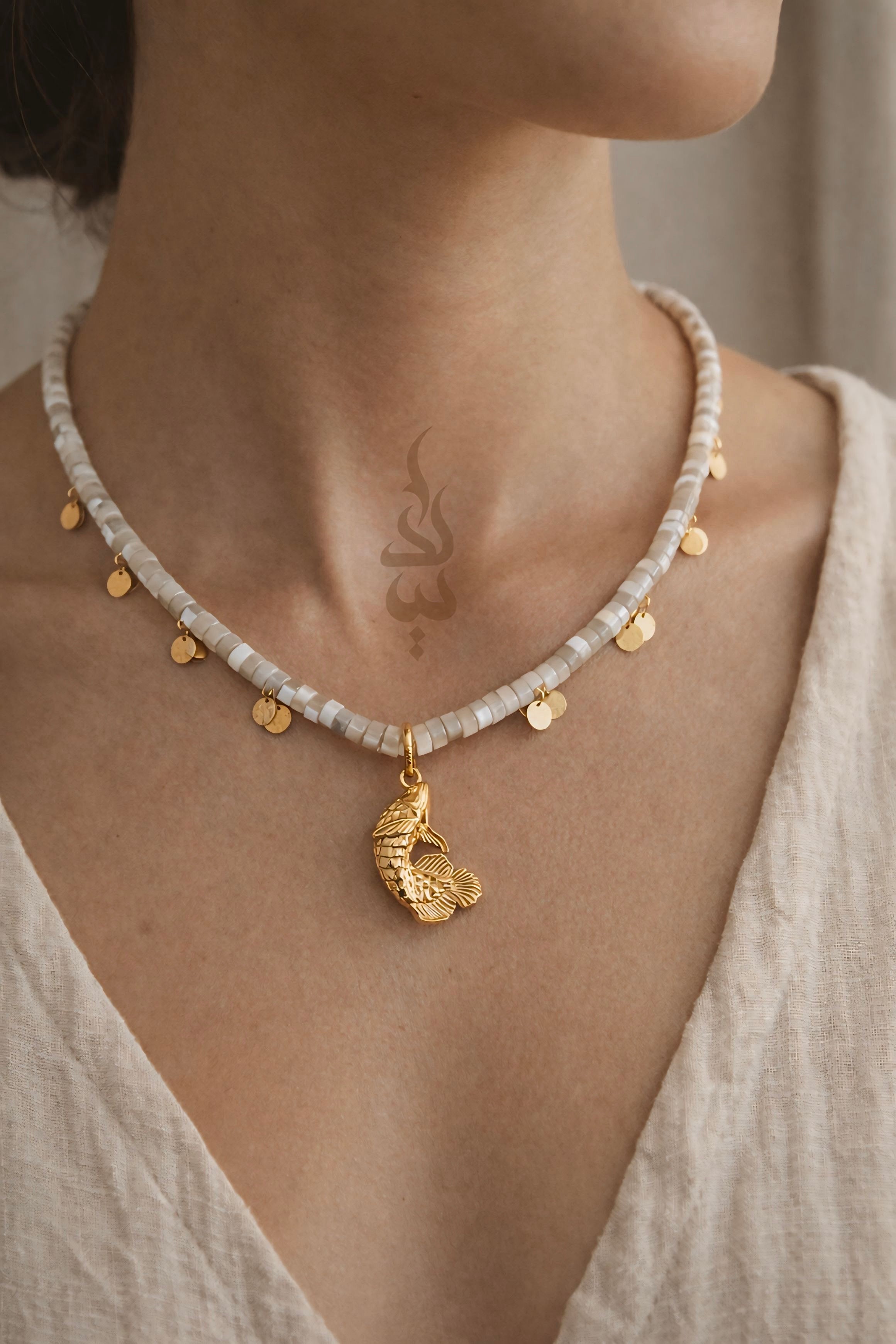 18K gold necklace with a fish pendant and shiny gold scales