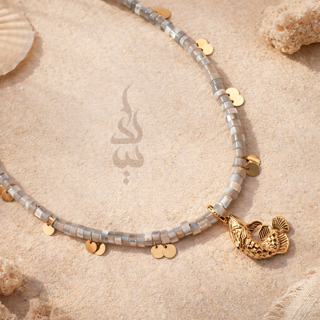18K gold necklace with a fish pendant and shiny gold scales
