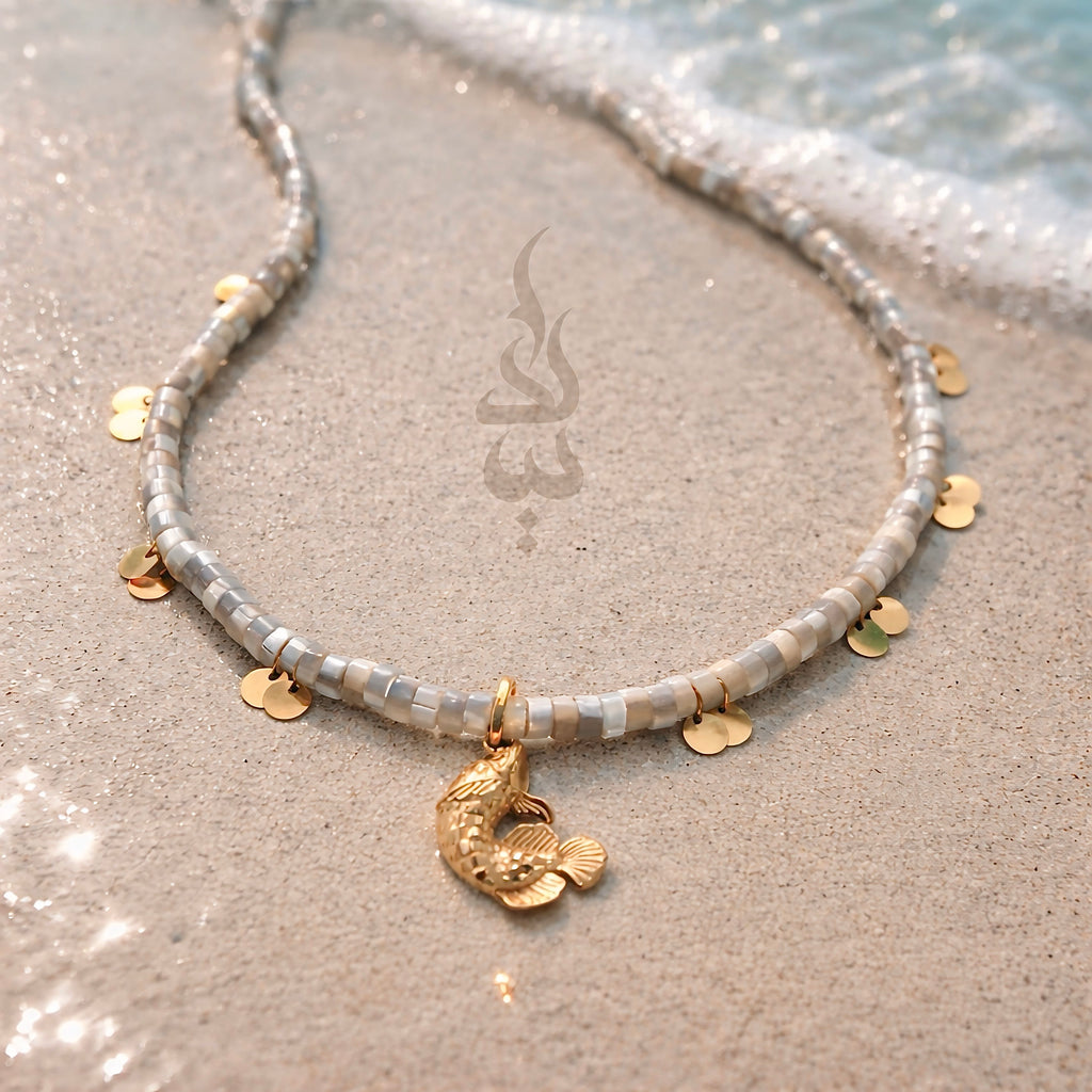 18K gold necklace with a fish pendant and shiny gold scales