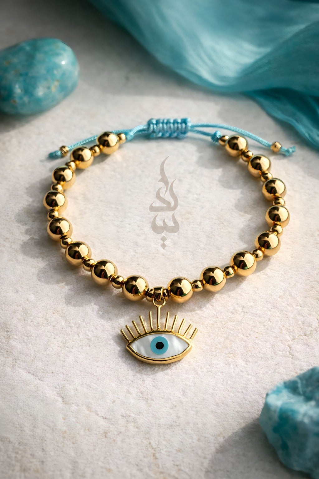 18K gold bracelet featuring polished gold beads with eye charm