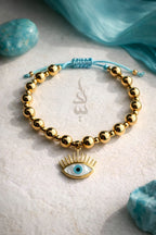 18K gold bracelet featuring polished gold beads with eye charm