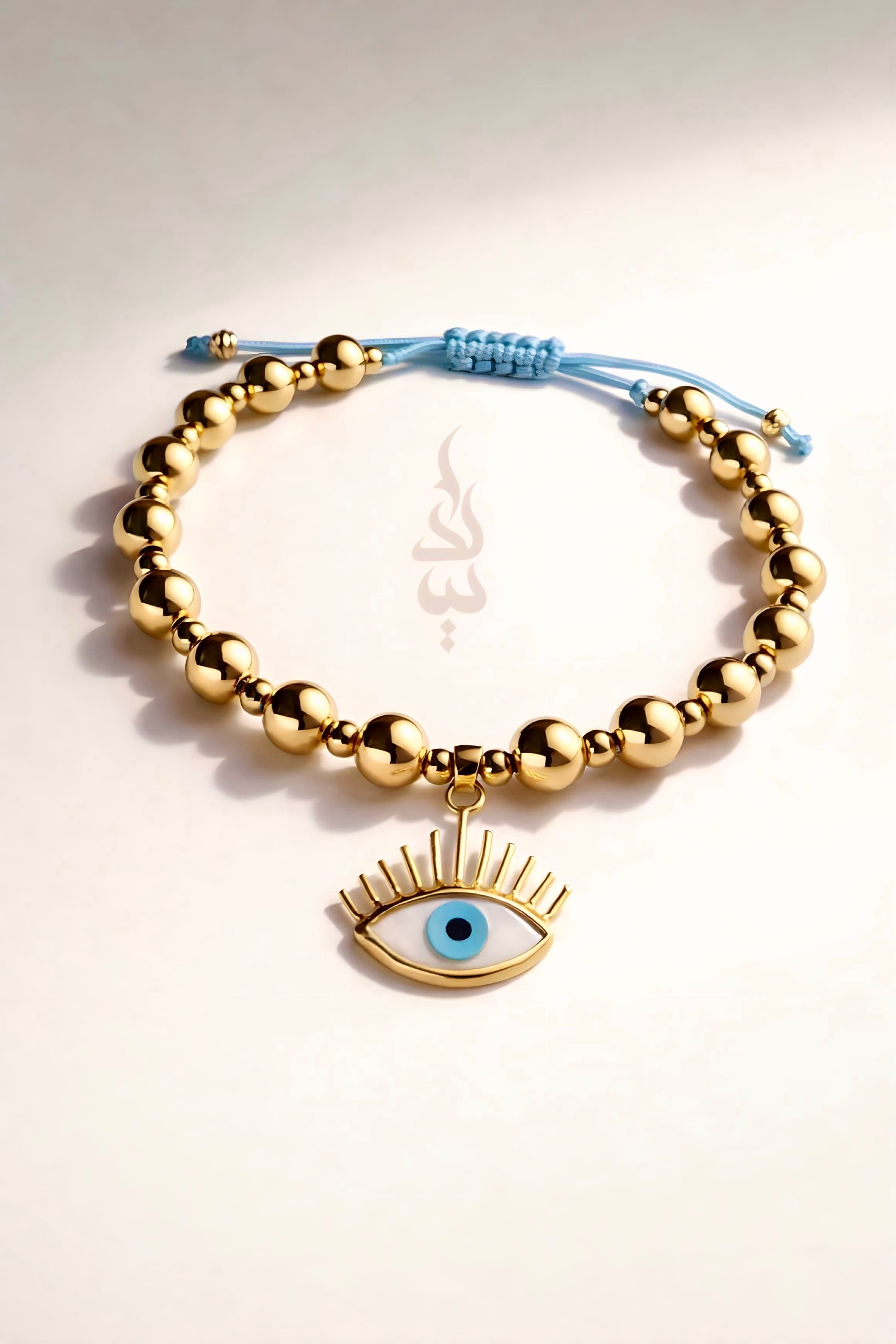 18K gold bracelet featuring polished gold beads with eye charm