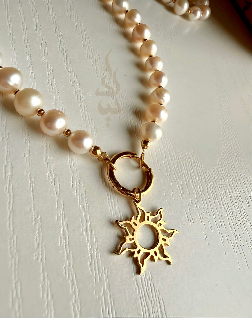 18K gold pearl necklace with sun pendant
