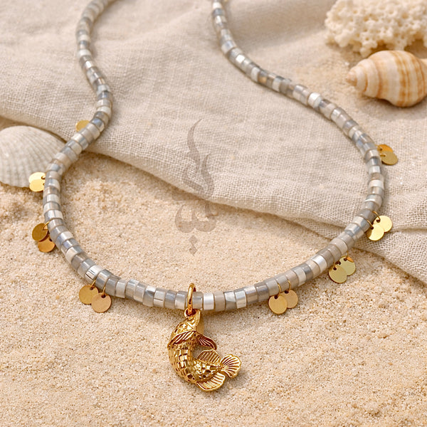 18K gold necklace with a fish pendant and shiny gold scales